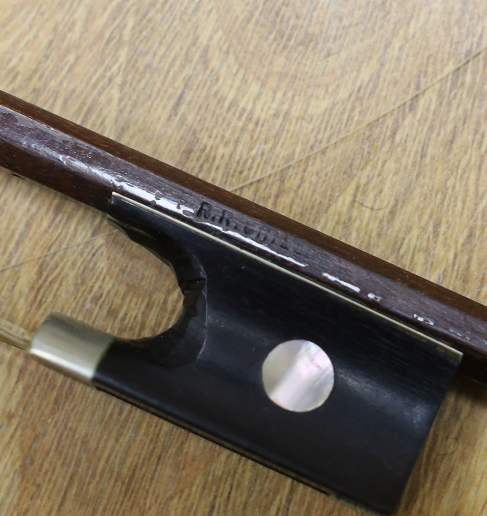 Three nickel mounted violin bows, one stamped R. R. Shields, two with ivory veneered tip - longest 75cm